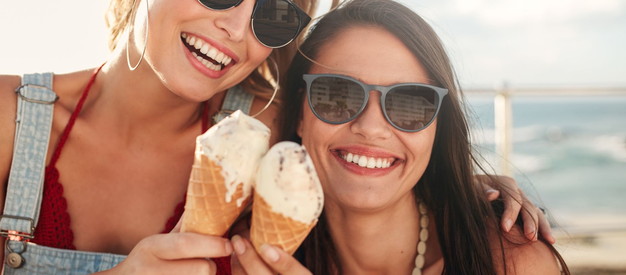 Two women celebrating summer in San Francisco, eating ice cream by the beach; Zelos Hotel offer Zelos Beat The Heat